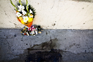 Bouquet of flowers with candles on Nogales (Mexico) sidewalk