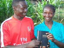 Africans holding a new Bible