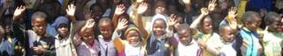Ntatshana Primary School children waving in thanks for their new classroom Ntatshana Primary School children waving in thanks for their new classroom