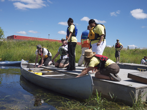 Family getting into a canoe